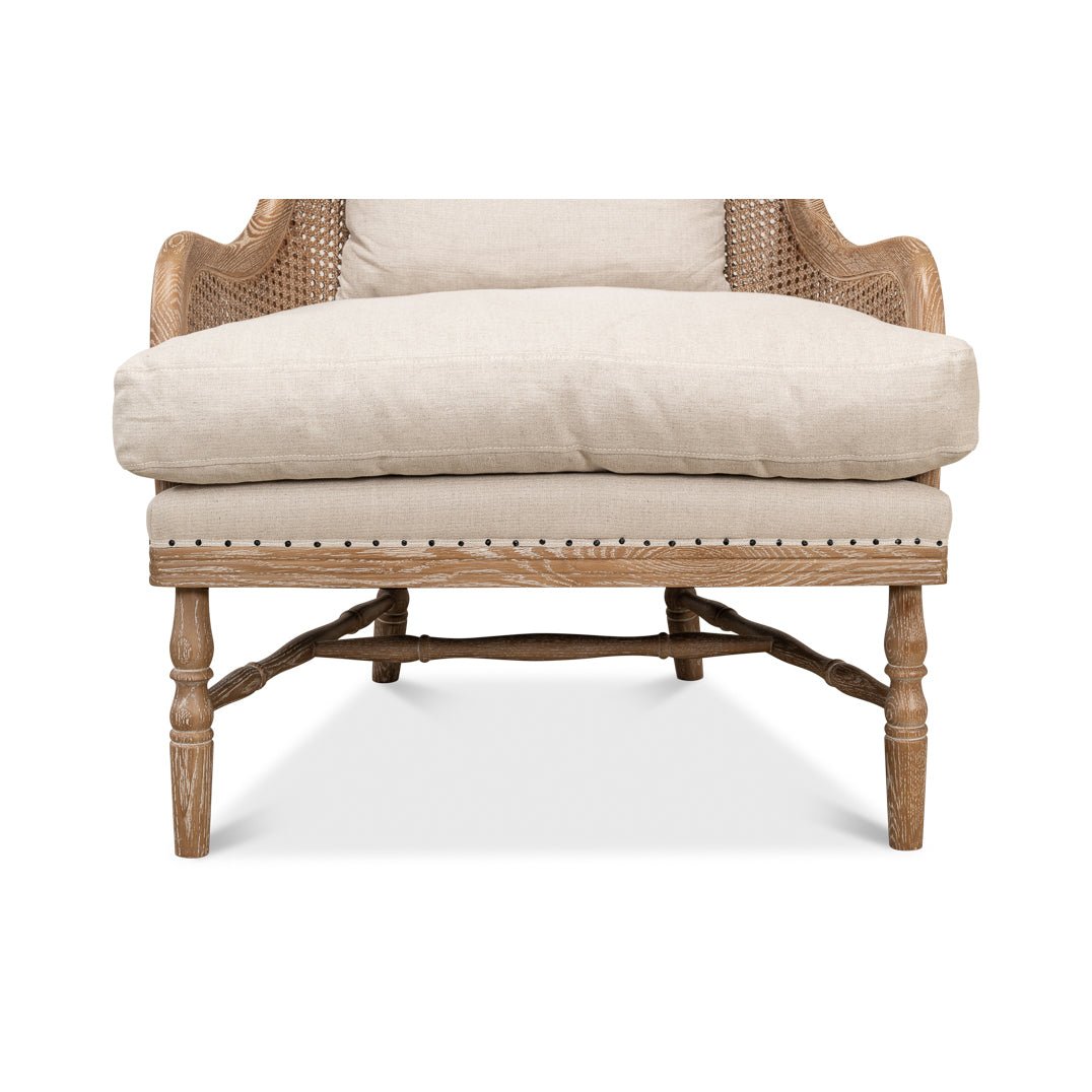 Close-up of armchair front legs and cushion.
