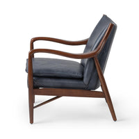 Side view of the Ocean Blue leather chair showing curved ash arms and tapered legs