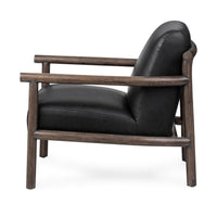 Side view of the black leather chair showing its open wood frame and angled back