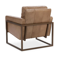 Rear three-quarter view of the tan leather chair showing paneled upholstery and iron rails