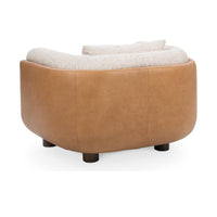 Rear view of the Latte accent chair showing its rounded tan leather back