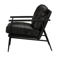 Side view of the Jet Black leather chair showing its angled back and splayed iron legs