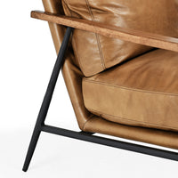 Adobe Tan leather chair detail showing the armrest, piped cushions and angled iron support