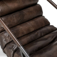 Truffle Brown leather chair detail showing padded channels and a slim iron arm