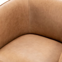 Close-up of the tan leather swivel chair's inner back and seat