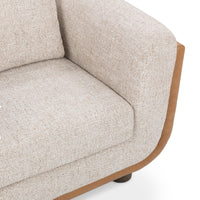 Close-up of the Latte chair's woven seat and arm with tan leather edging