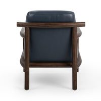 Rear view of the Mystic Blue leather chair with a projecting rounded wood back rail