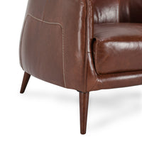 Spiced Brown leather chair side detail showing cream contrast stitching and a tapered oak leg