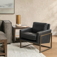 Jet Black leather accent chair with a brass-finished frame styled beside a sofa