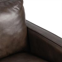 Truffle Brown leather chair detail showing the back cushion and piped armrest