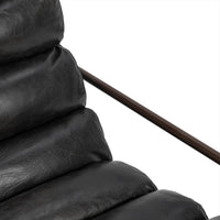 Jet Black leather chair detail showing the padded back channels and slim iron arm