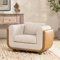 Latte leather-backed accent chair styled beside a carved console on a patterned rug
