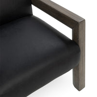 Black leather seat and broad wood arm detail on the open-frame accent chair
