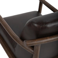 Dark Roast leather chair rear detail showing the curved wood rail and stitched cushion