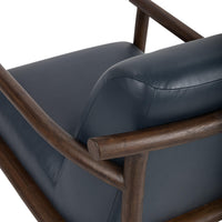 Mystic Blue leather chair rear detail showing the curved wood rail and stitched cushion