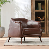 Spiced Brown leather accent chair with tapered wood legs styled beside a cabinet