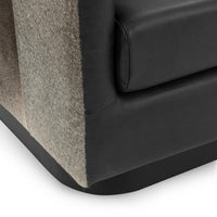 Onyx Black swivel chair lower corner detail showing hair on hide, piped seat and dark base