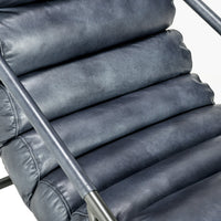 Ocean Blue leather chair detail showing the padded channels and slim iron arm