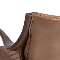 Close-up of tan leather back edge and curved ash frame