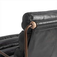 Rear headrest detail of the Jet Black leather chair showing the iron frame connection