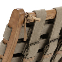 Rear corner detail showing woven canvas straps and a leather cushion tie on the ash frame
