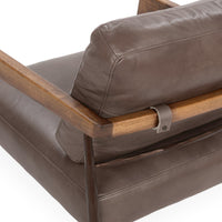 Rear cushion detail showing a leather strap fastened around the ash back rail