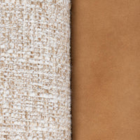Pale woven fabric and tan leather upholstery detail on the Latte chair