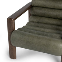 Soft Sage leather chair detail showing padded channels and the dark wood arm