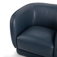 Mystic Blue leather swivel chair detail showing the curved inner back and piped seat