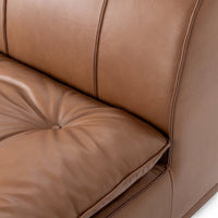 Close-up of vertical back seams and tufted seat on the toffee brown leather chair