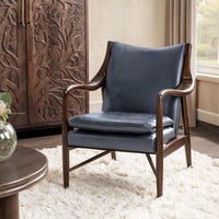 Ocean Blue leather accent chair with sculpted ash arms styled beside a carved cabinet