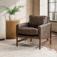Truffle Brown leather accent chair with a bronze-finished frame styled beside a wood side table