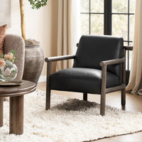Black leather accent chair with rounded wood arms styled beside a window