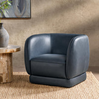 Mystic Blue leather barrel-back swivel chair styled beside a wood side table