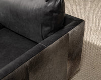 Onyx Black swivel chair upholstery detail showing the leather back cushion and hair-on-hide arm