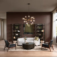 Two Jet Black leather accent chairs styled around a coffee table opposite a sofa