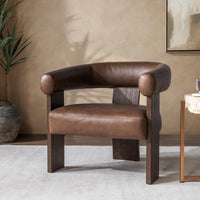 Rich Cocoa leather accent chair styled beside a small table and potted plant