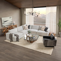 Onyx Black hair-on-hide swivel chair styled beside a sectional and glass coffee table