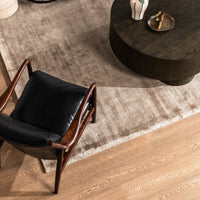 Overhead view of the Jet Black leather accent chair styled beside a round coffee table