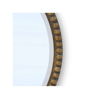 Detailed view of wooden bead design on mirror.