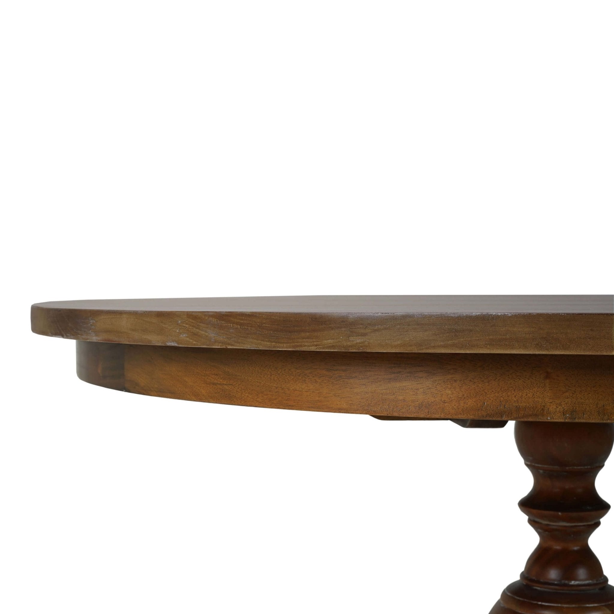 Close-up of dining table edge and pedestal detail.