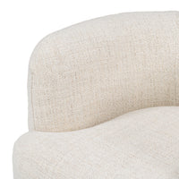 Close-up of the Natural chair's textured fabric seat and rounded inner back