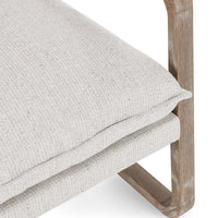 Close-up of the Natural chair's flanged seat cushion and curved wood support