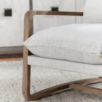 Natural chair seat cushion and wood sled frame shown close-up in a room setting