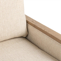 Close-up of the Natural chair's seat, back cushion and ash wood arm