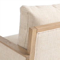 Rear detail of the Natural chair's ash frame, back cushion and piped fabric panel