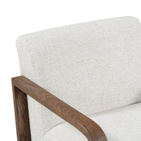 Close-up of the Coastal Breeze chair's pale back cushion and grained ash arm