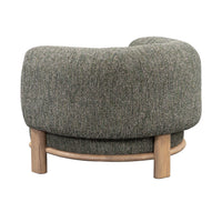 Back view of the Green chair with curved upholstery above an exposed ash base