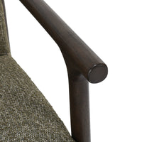 Close-up of the Kale Green chair's rounded dark wood arm and joint
