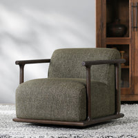 Kale Green swivel chair styled on a rug beside a wooden cabinet
